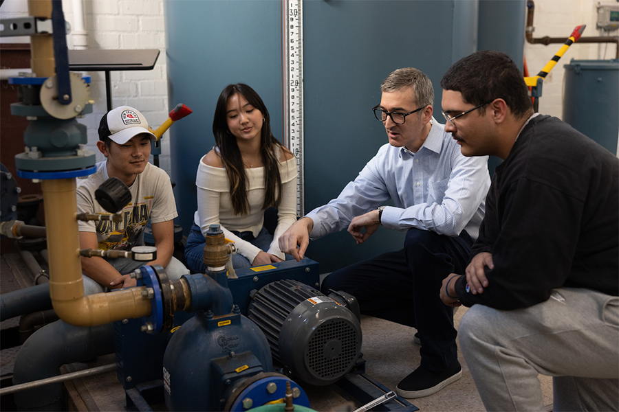 Civil engineering professor talking to LMU students in lab